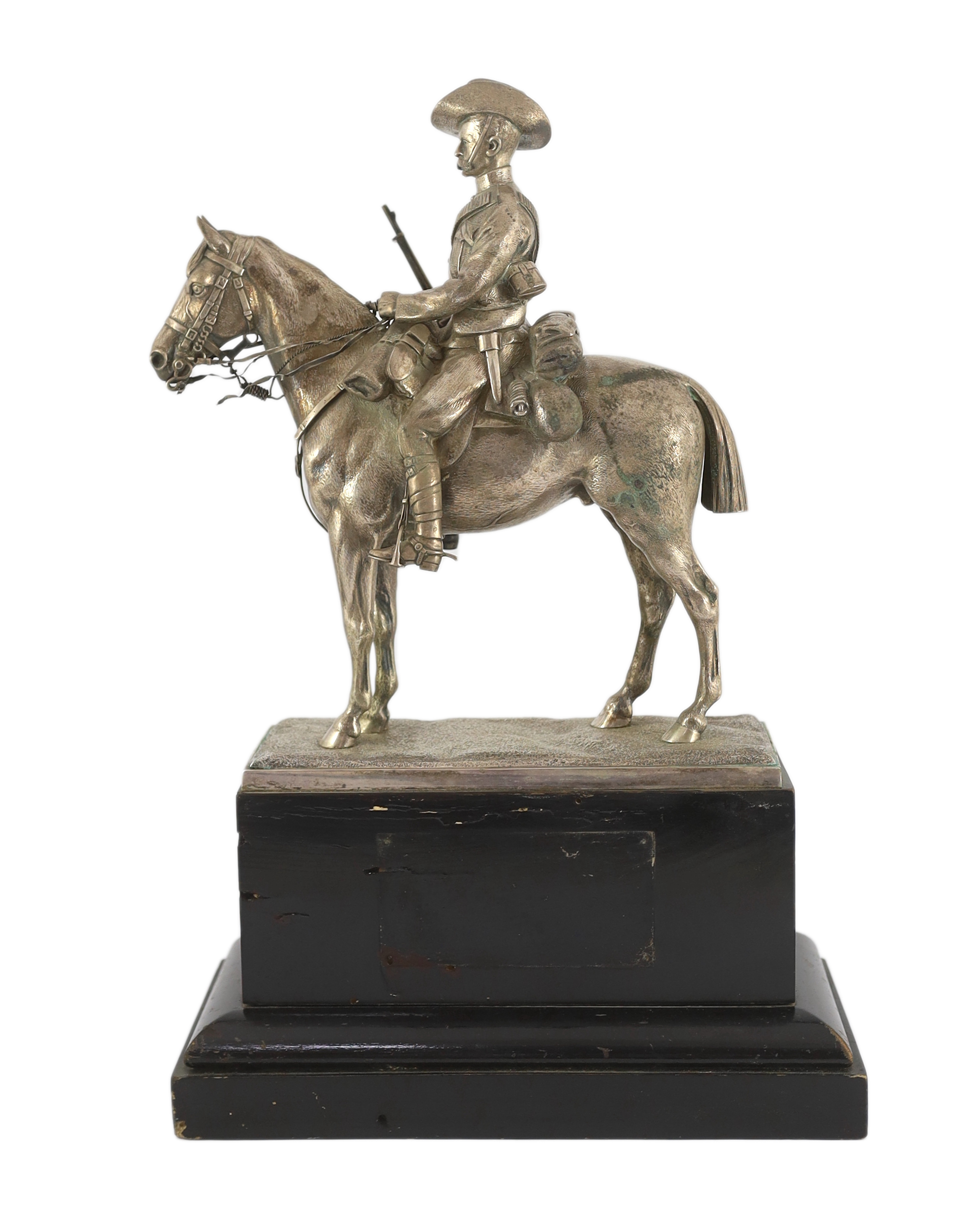 An early 20th century silver model of a City Imperial Volunteer, holding a rifle, on horseback, early 20th century